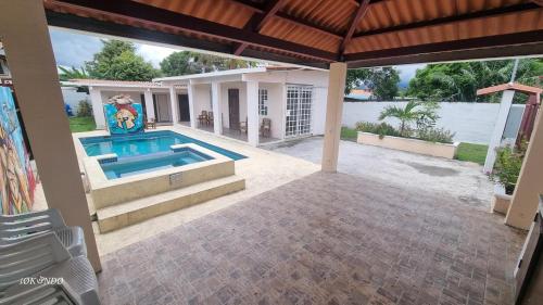 a patio with a swimming pool and a house at Casa Troya in Nueva Gorgona