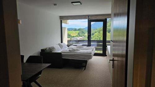 a hotel room with a bed and a window at Refugium.311 in Bad Reichenhall