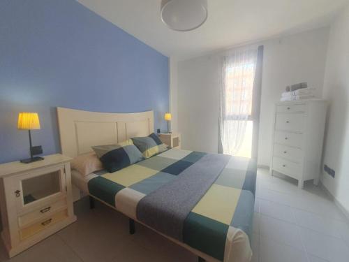 a bedroom with a bed and a dresser and a window at Duplex Beach Cabezo 2h terrace in El Médano