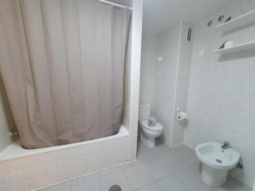 a white bathroom with a shower and a toilet at Duplex Beach Cabezo 2h terrace in El Médano