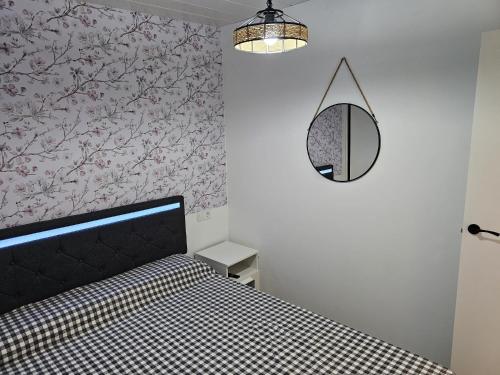 a bedroom with a black bed and a mirror at O Alpendre in Bueu