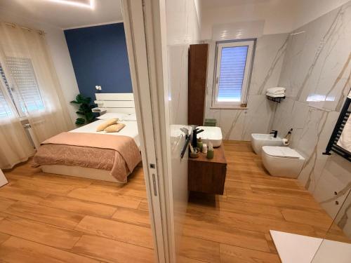 a bedroom with a bed and a bathroom with a toilet at Palazzo del Toro 2 in Montesilvano