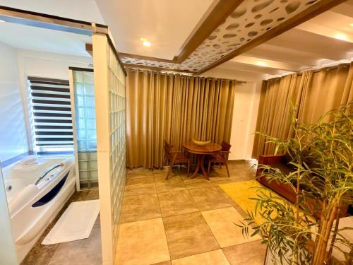 a bathroom with a table and a bath tub and a table at Silver Green Resort in Wayanad