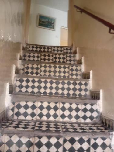 a stairway with a checkered floor at Dar Al Medina in Casablanca