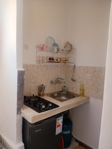 a small kitchen with a sink and a stove at Dar Al Medina in Casablanca