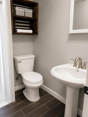 a bathroom with a toilet and a sink at Cozy Private Studio in Des Moines