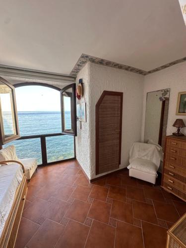 a bedroom with a view of the ocean at Marea Chianalea in Scilla