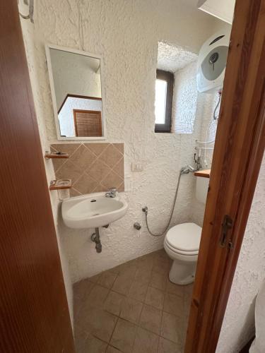 a bathroom with a sink and a toilet and a mirror at Marea Chianalea in Scilla