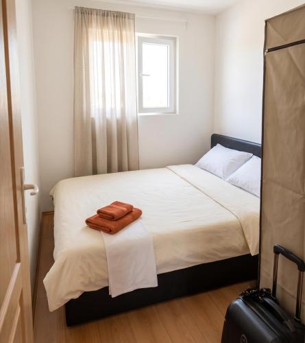 a bedroom with a bed with two towels on it at Villa Lila in Dolno Dupeni