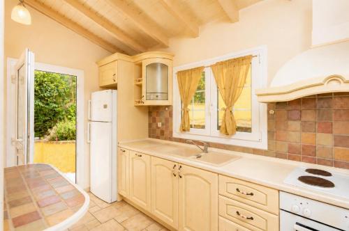 a kitchen with a sink and a refrigerator at Ioannas House in Nisaki