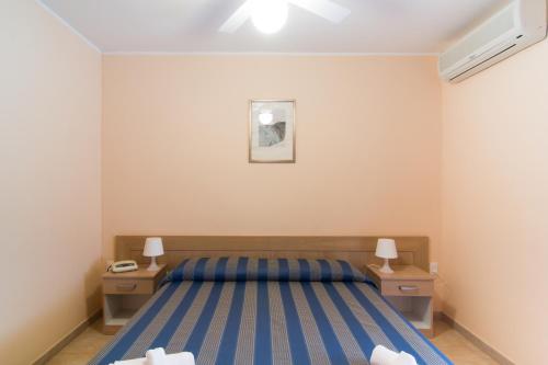 a bedroom with a bed and two night stands at Racar Hotel in Frigole