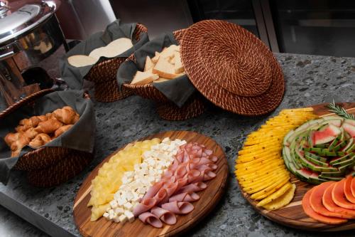 a table topped with plates of different types of food at Blues Suites Laureles in Medellín