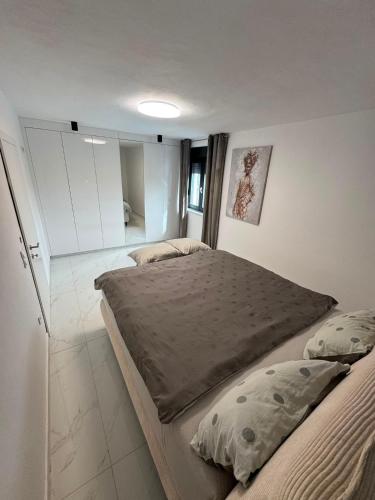 a bedroom with two beds in a room at Plitvice House Lina in Rakovica