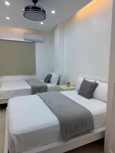 a bedroom with two beds and a chalkboard on the wall at Apartamento Carmen céntrico in Santa Bárbara de Samaná