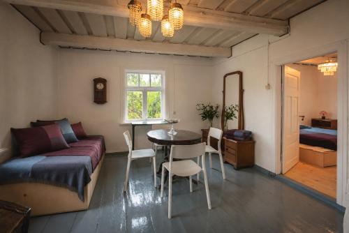 a bedroom with a bed and a table and chairs at Retreat House in Lauvas