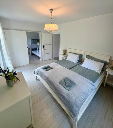 a bedroom with a large bed and a table at Sosnowy Zakątek in Radęcin
