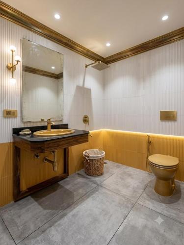 a bathroom with a sink and a toilet at Tripo bay inn in Mahabalipuram