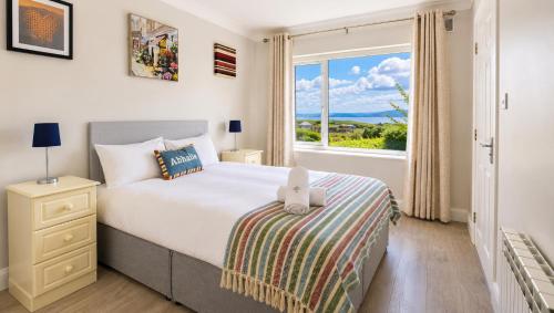 a bedroom with a bed and a large window at SeaClusion Barna in Barna