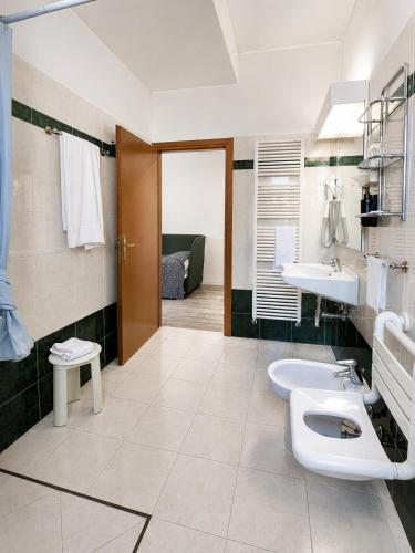 a bathroom with two sinks and two toilets at Hotel Italia in Ravenna