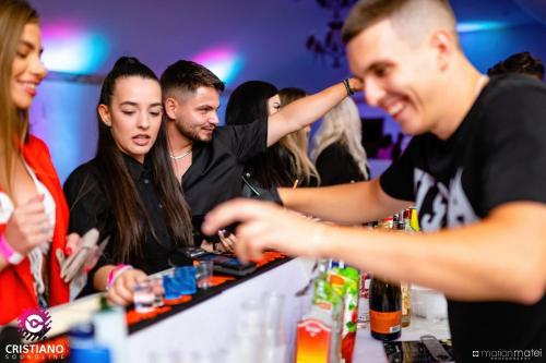 a group of people at a bar at a party at Villa Franca Luxury Chalets in Sighişoara