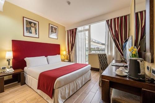 a hotel room with a bed and a large window at Cardinal Hotel St. Peter in Rome