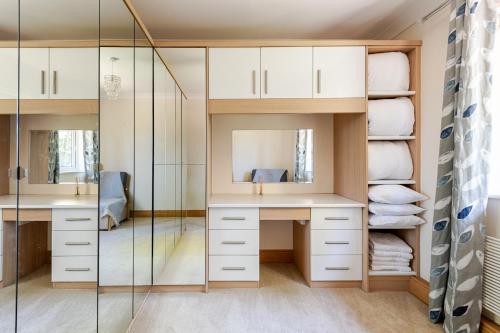 a bathroom with two sinks and a glass shower at The Limes Bungalow in Market Rasen