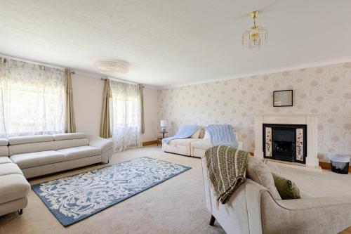 a living room with two couches and a fireplace at The Limes Bungalow in Market Rasen