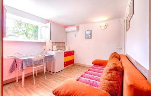 a living room with a couch and a table at Studio Southwest 1 with AirCon & FREE Parking in Ljubljana