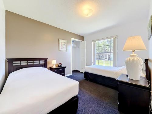a hotel room with two beds and a window at 3BR Home Trailside Pool & Jacuzzi, Minutes from Inverness, Ocala & Crystal River in Inverness