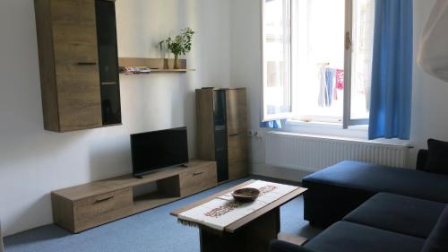 a living room with a couch and a tv at Zámecký areál Dub in Dub