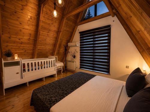 a bedroom with a large bed and a window at Area36 Family Chalet in Gabala