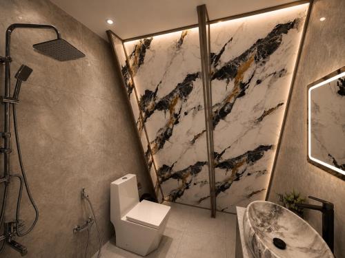 a bathroom with a shower and a toilet and a sink at Area36 Family Chalet in Gabala
