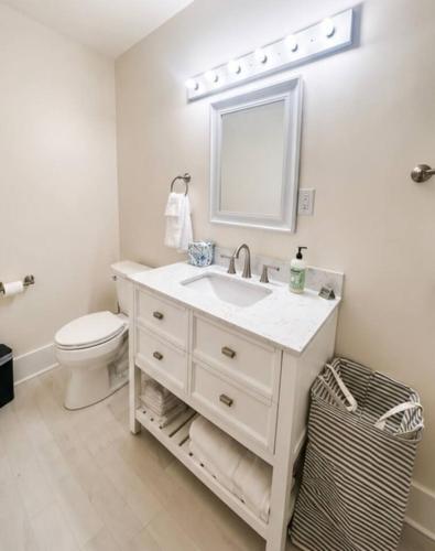 a white bathroom with a sink and a toilet at Main Street Stay in Georgetown