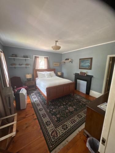 a bedroom with a bed and a rug at The old parsonage bed and breakfast in Kennebunkport