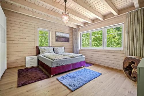 a bedroom with a bed in a room with wooden walls at Schwedenhaus Eichenberg in Eichenberg