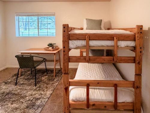 a bedroom with two bunk beds and a desk at Lake and Mountains, 3BR 2BA in Show Low