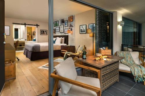 a living room with a room with a bed and a desk at Hotel Paradox, Autograph Collection in Santa Cruz