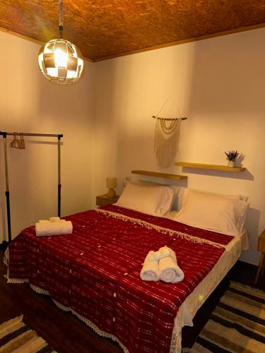 a bedroom with a large bed with towels on it at Guest House Keli in Nënshat