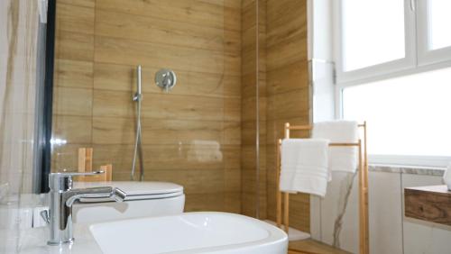 a bathroom with a white toilet and a shower at Aura Apartments in Pompei