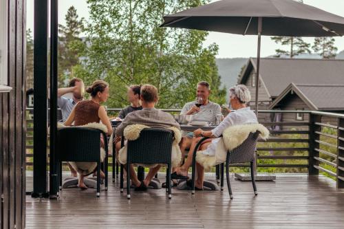 a group of people sitting at a table on a deck at Chalet Vradal in Vradal