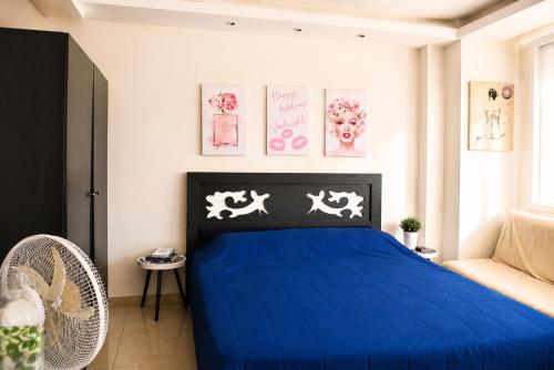 a bedroom with a blue bed and a chair at chalet in Saint remon in Al ‘Ayn