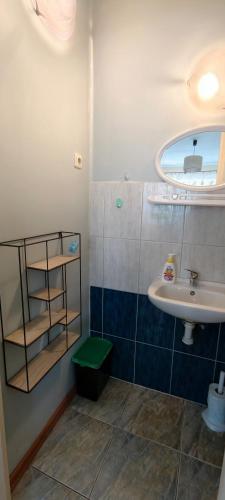 a small bathroom with a sink and a mirror at Pokoje gościnne Małgorzata Dąbrowska in Kołobrzeg