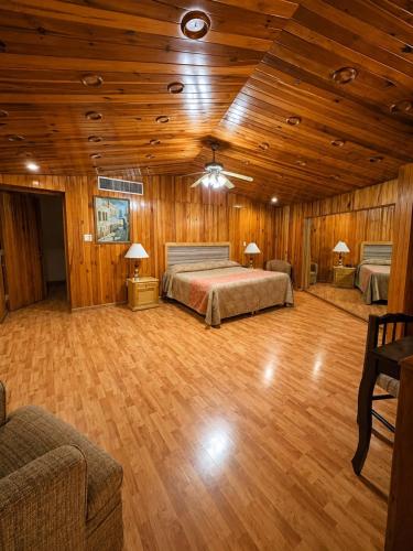a bedroom with a bed and a wooden ceiling at Meson de la Merced in Zacatecas