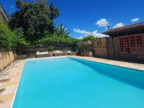 a swimming pool in the backyard of a house at Pousada 14 Bis in Petrópolis