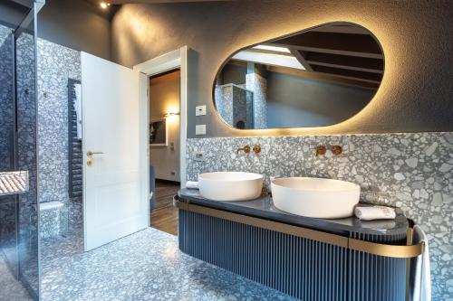 a bathroom with two sinks and a mirror at Palazzo Utini in Noceto