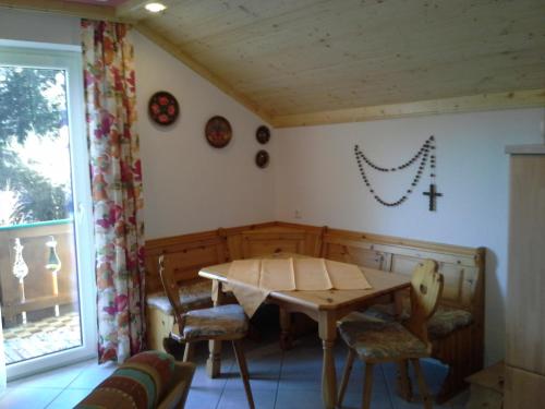 a dining room with a wooden table and chairs at Waldhaus in Hinterstoder
