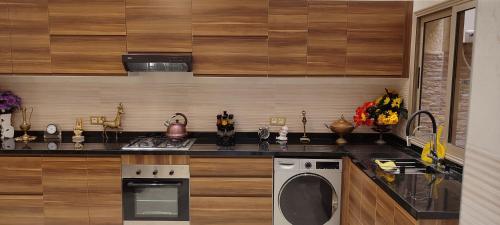 a kitchen with a stove and a dishwasher at تاركة مراكش in Marrakesh