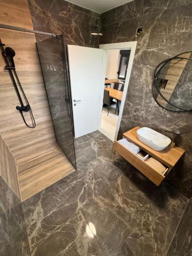 a bathroom with a toilet and a glass shower at Plitvice House Lina in Rakovica