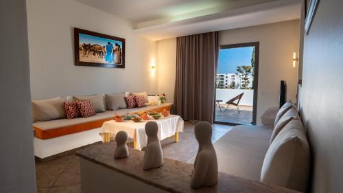 a living room with a couch and a table at Intouriste Hotel & Suites in Agadir