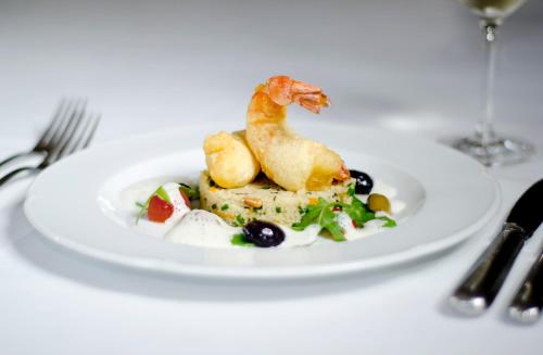 a plate with a piece of food on a table at Landgasthof zur Sonne in Wehr